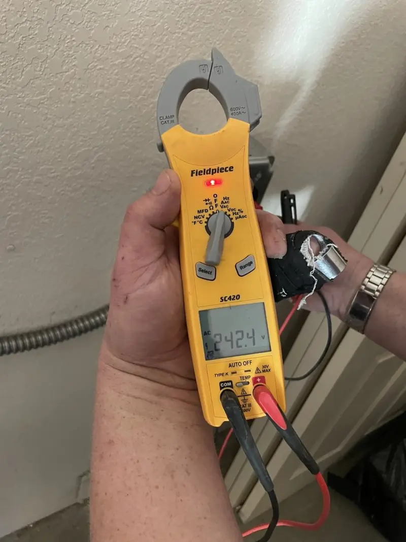 Voltage testing with clamp meter during Outlet Installation in Canutillo